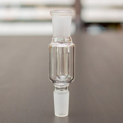Glass dry herb catcher on a table.