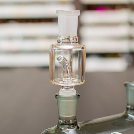 Glass dry herb catcher in a waterpiece.